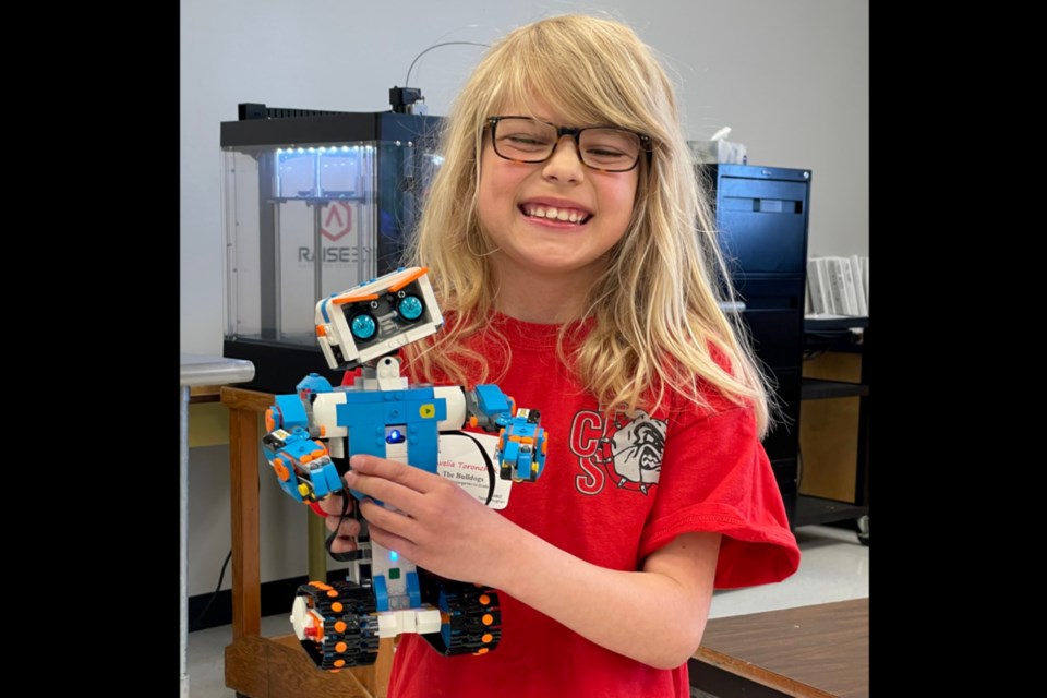 Avelia Toronchuk is a Grade 3 student from Thorhild Central School which hosted students from across the Aspen View Public Schools division for a Robotics Challenge day. In the demonstration room she played with a Lego Bot, a robot made of Lego while 3D printers whirred in the background making parts for other robots. 