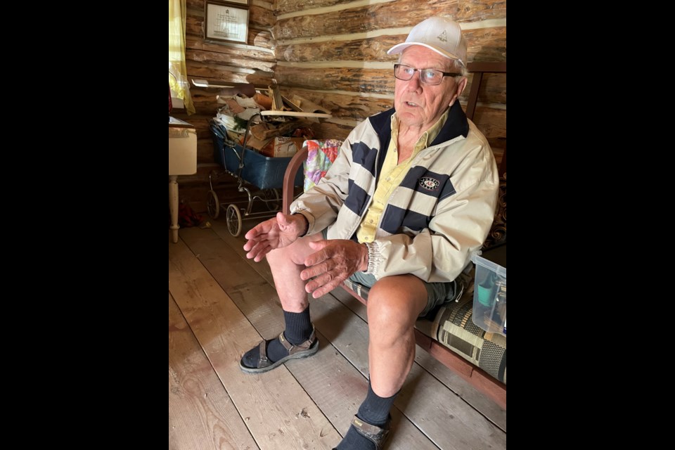 Rudy Wiselka sits on a bench he refurbished inside the original homestead house his father built in 1929 for his mother and three sisters. Wiselka never lived in the one-room home but spent summers sleeping in it with his brother when the family home, built a few years after this one, became too hot.