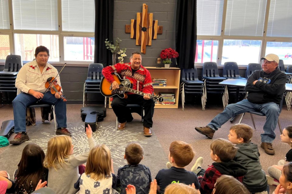 Bryce Delorme plays his fiddle, while James Cardinal plays guitar, joined by Stan Delorme in the Boyle School library to let the students hear some traditional Métis music during Métis Week, Nov. 13 to 19. Cardinal is also the president of Region 1 of the Métis Nation of Alberta.