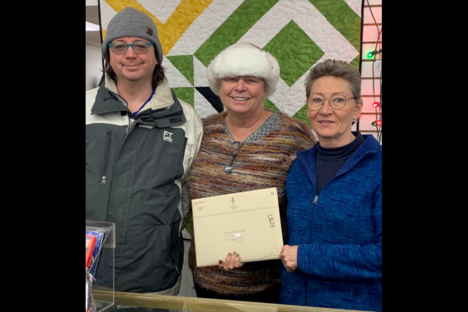 Sherrie Breese may have been awarded a rare pin made in honour of Queen Elizabeth’s 70 years as the head of the Commonwealth, but she shares it with her staff and family. Pictured, Breese's son Michael Borody, Breese and Carmen Beaudet. 