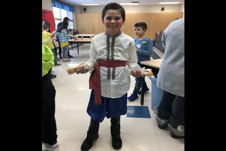 Bauer Brassard proudly showing off his heritage wearing a traditional Ukrainian costume with two hotdogs in hand at Boyle School’s March 4 fundraiser, which raised more than $6,000 for the Red Cross.