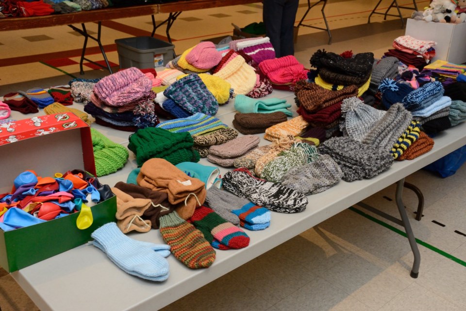 Hand-knitted toques, mittens and scarves fill a table at the Barrhead Alliance Church on Nov. 23, which was “packing day” for the local Operation Christmas Child campaign. Barrhead and area crafters went all out for this year’s campaign, donating hundreds of hand-crafted items to be placed in shoeboxes.