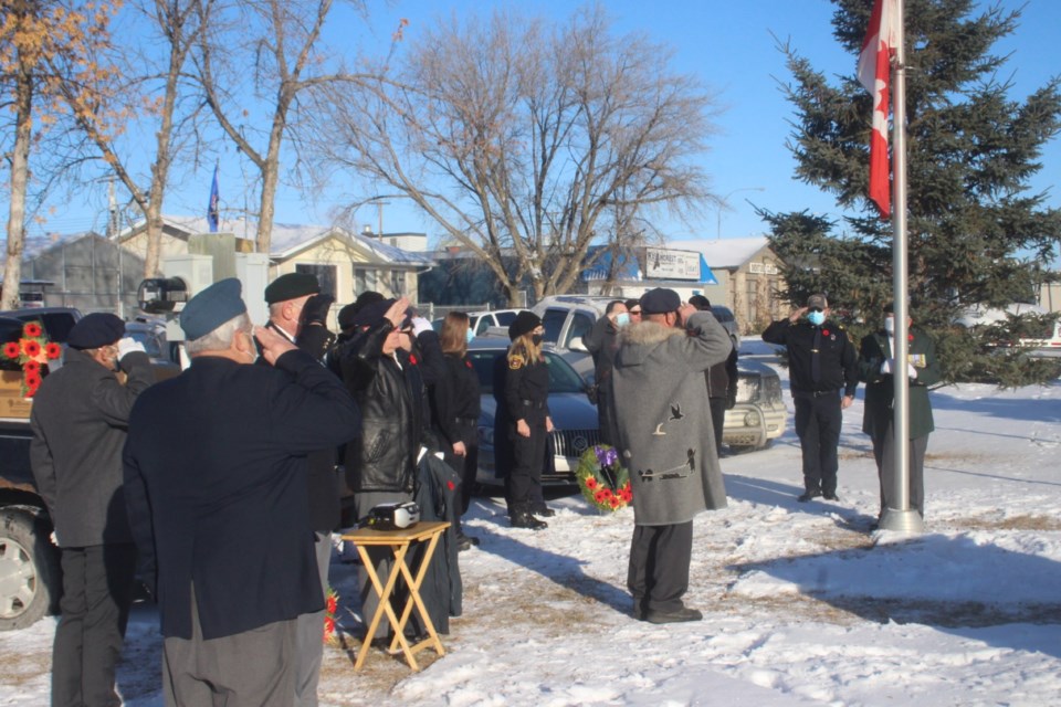 Members of the Royal Canadian Legion in Barrhead and others salute as the Canadian flag is lowered to half-mast at the Barrhead Memorial Park on Nov. 11. This year's Remembrance Day ceremony was fairly short due to the COVID-19 pandemic; normally, a lengthy ceremony would be held at the Barrhead Elementary School with hundreds in attendance. Even so, there were perhaps 40 to 50 residents in attendance at the brief ceremony.