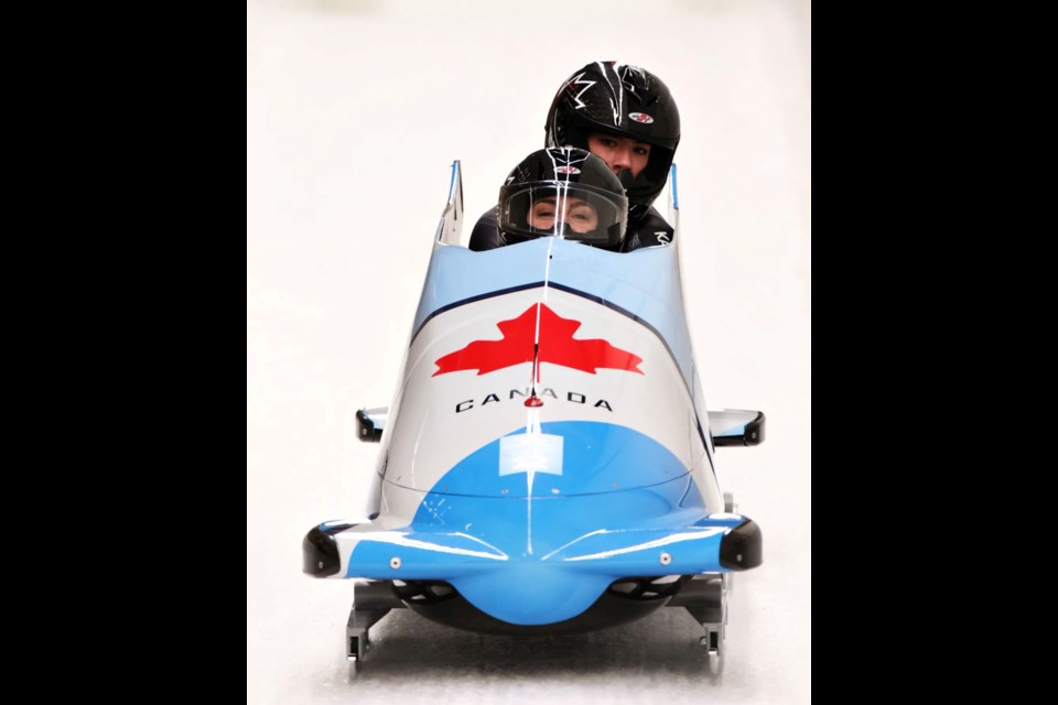 Melissa Lotholz and her partner Sara Villani come to a stop at the finish line after a successful bobsleigh run.