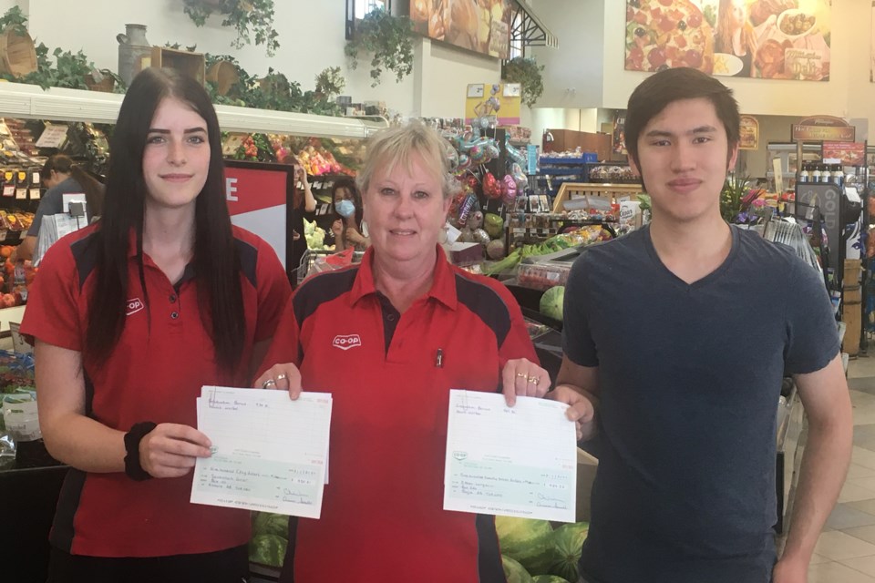 Boyle School grads Savannah Grier and Ethan Langevin receive cheques from Boyle grocery supervisor Willa Fox July 29 as part of North Corridor Co-op’s student graduate program. In all, more than $4,000 was gifted to the grads.

