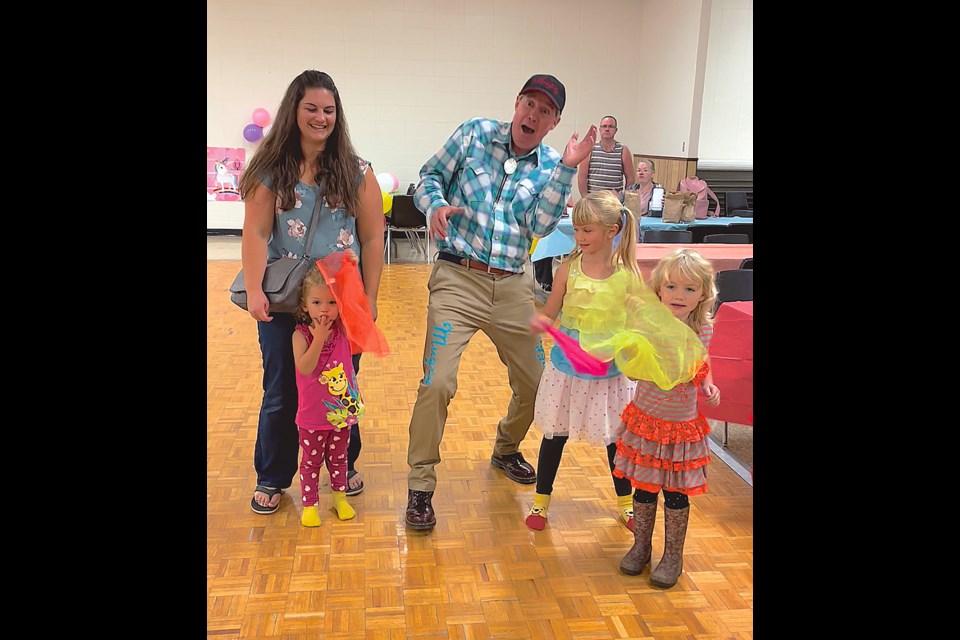 Angels in Motion held a fall fair at the Boyle Community Centre Oct. 1, ushering in the new season with tons of games and fun for youngsters. From a bouncy castle to a photo booth, there was something for everyone with about 60 kids at one point taking part in the action. Pictured, Mom Stephanie Splane laughs as daughters Bethany, 2, Lillian, 7, and Vanessa, 4, have some fun with “Mugsy the Clown.”