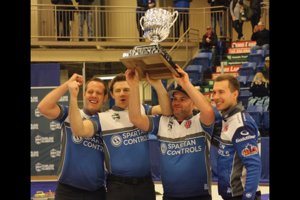 The Brendan Bottcher rink of (L-R) Karrick Martin, Bradley Thiessen, Darren Moulding and Bottcher hold the Alberta Provincial Men’s Championship trophy overhead in celebration of a hard fought win against the Sturmay rink Feb. 9 at the Rotary Spirit Centre.
Photo by Chris Zwick/WN