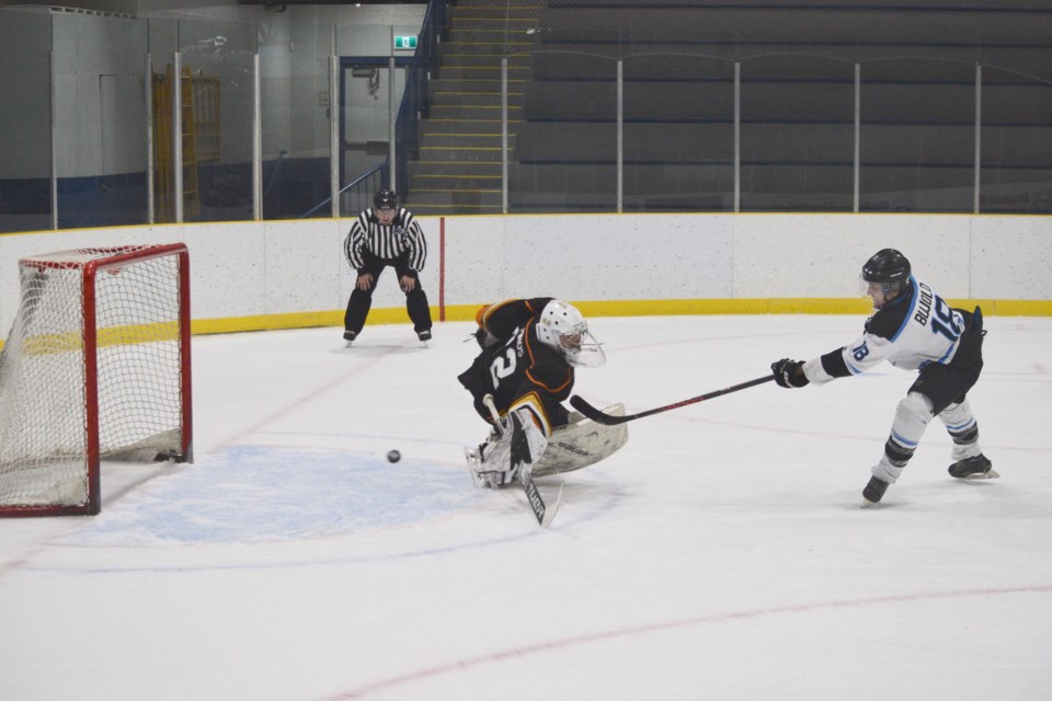 Barrhead Bombers forward Brendan Bujold putting the puck behind Hinton Timberwolves goaltender Dimitrius Virostek in the shootout to secure the victory.