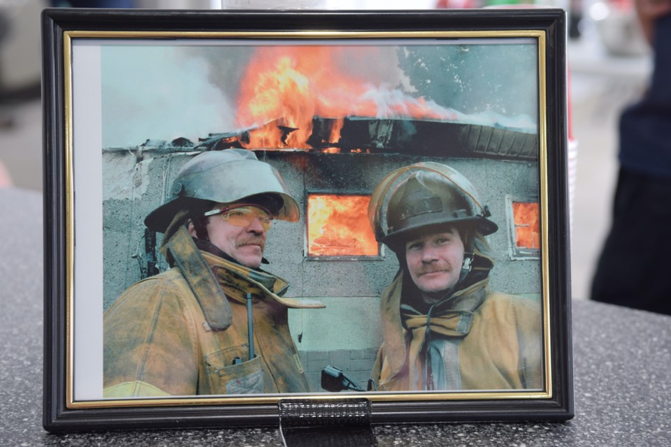 A picture of Carl "Hollywood" Hulsemann (left) with former Barrhead Regional Fire Services firefighter and current Red Knights president Don Smith was displayed at the community barbeque staged after the motorcycle club's July 29 charity ride. The picture was taken sometime in the 1990s.