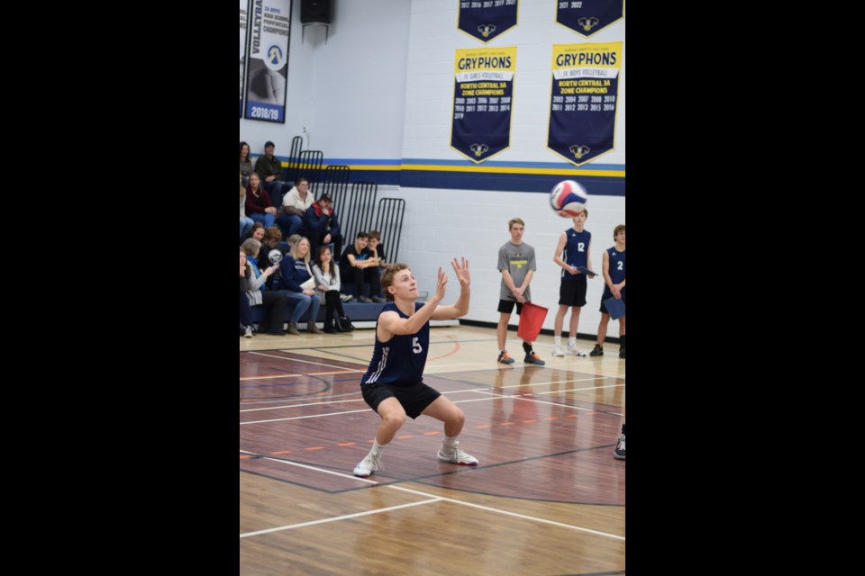  Gryphon Carter Roszko sets the ball over to his Morinville opponents in a round-robin game in the Alberta 3A North Central Zone tournament on Nov. 17.