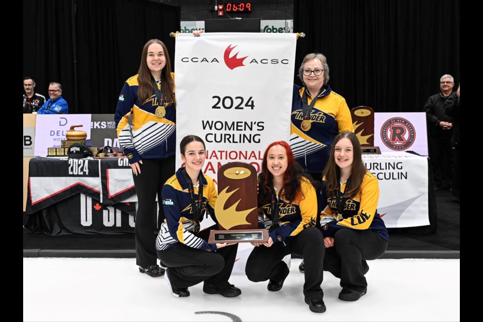 The Concordia Thunder pose with the CCAA Championship banner. Pictured back row from left is third Payton Sonnenberg and coach Tania Smiley. Front row from left is skip Gabrielle Wood, second Brenna Bilassy and lead Rachel Jost.