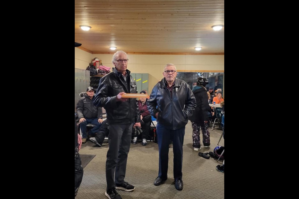 Long time County of Barrhead councillor (left) Dennis Nanninga presents George Visser, one of the original Misty Ridge Ski Hill board members, with a plaque celebrating the ski hills' 50th anniversary during a special March 5 event.