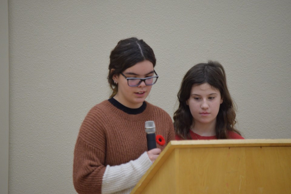 Fort Assiniboine School students Shelby Rondeau and Ali Druar act as MCs during the school's Remembrance Day service.
