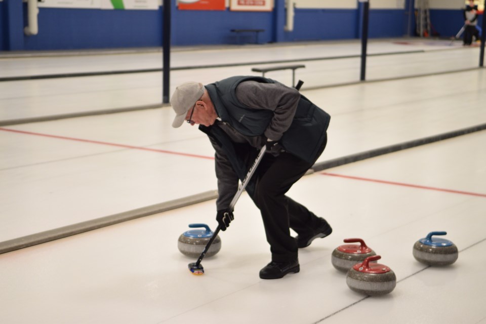 Glen Plischke sweeping his wife Joanne’s rock.