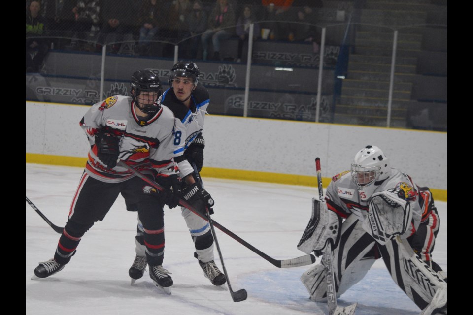 Barrhead Bomber forward Daytin Catt (in blue) fights for position in front of the Edmonton net during a power-play in the second period against Edmonton Eagles defenceman Reece McDonald. Catt ended the game with four assists.