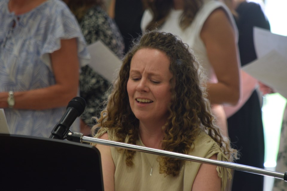 Lisa Seatter leads the NPCS staff in singing the "Goodness of God."