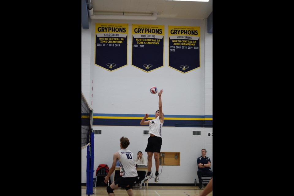 Barrhead Gryphon Ian Van Dijk with a jumping spike in a game against Sturgeon Sturgeon Composite High School. Markus Rottier is in the foreground.