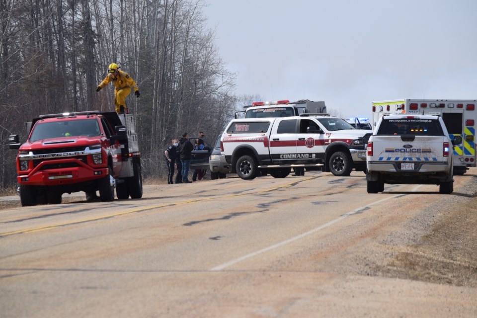 Emergency personnel temporarily close Township Road 592 to traffic due to an April 22 wildfire.