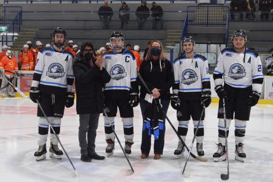 The Barrhead Bombers presented Aubrey Schatz with a $2,100 cheque from their fundraising efforts during the pregame ceremony at the Barrhead Bombers Nov. 27 game against the Edmonton Vipers. Pictured from left is assistant captain Austin Davis, Barrhead Bombers' owner Aly Virani, captain Presley Toth, Kristie Schatz and assistant captains Austin Strathdee and Chad Esperance.