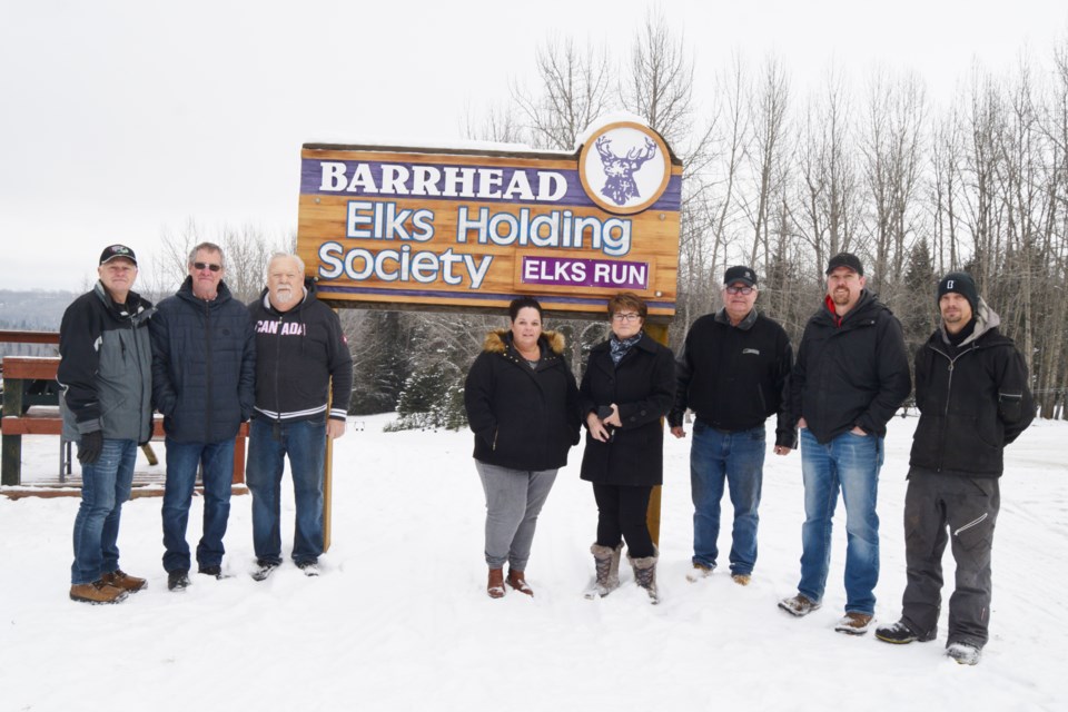 The Misty Ridge Ski Hill Society noted the installation of their new ski lift wouldn't have been possible without the help of the Barrhead Elks. To commemorate their efforts the society installed this sign near the entrance to the bunny hill and the new T-bar lift. L-R: Barrhead Elks members Cal Fischer, Bruce McLean, Bill Lane and Shelley Van Bee along with society members Louise and Jim Miller, Matthew Swan and Greg Reschke. 
Photos by Barry Kerton/BL