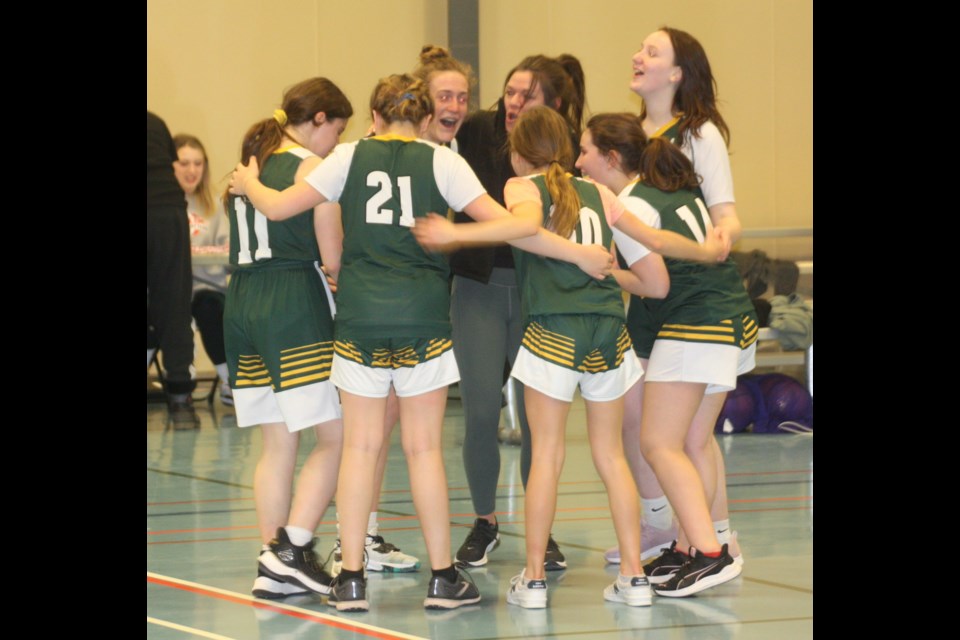 The Fort Assiniboine girls' basketball team celebrate after winning the Junior High Tier 2 Basketball Championship final hosted at the Westlock Rotary Spirit Centre on Feb. 27. The team includes Ali Druar, Gracie Koster, Lina Kafka, Isa Kafka, Liel Yaakobi, Lucy Schmid and coach Rhonda Spitzer.