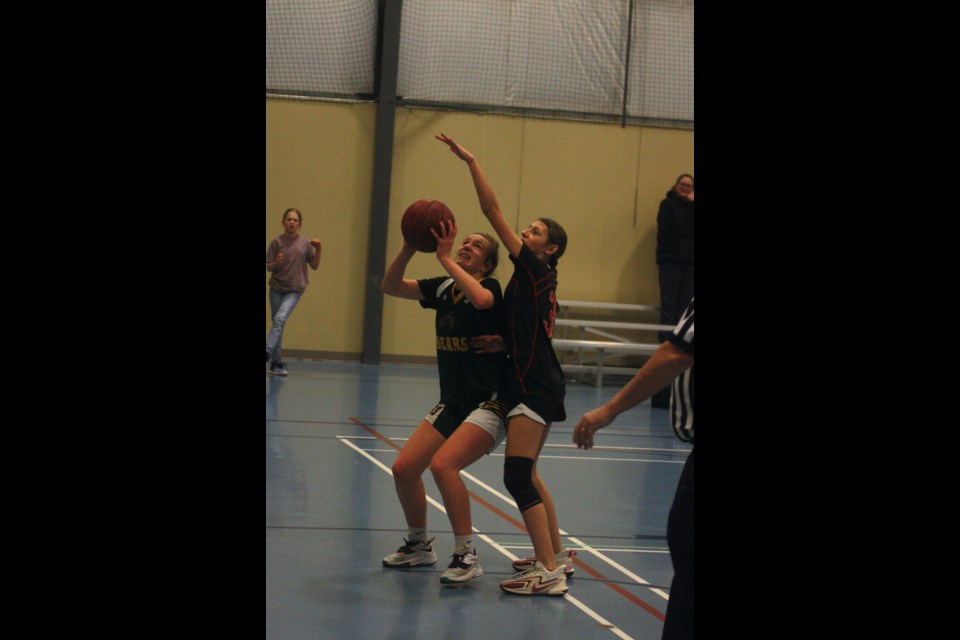 Lina Kafka gets ready to shoot a basket despite being blocked by a R.F. Staples player.