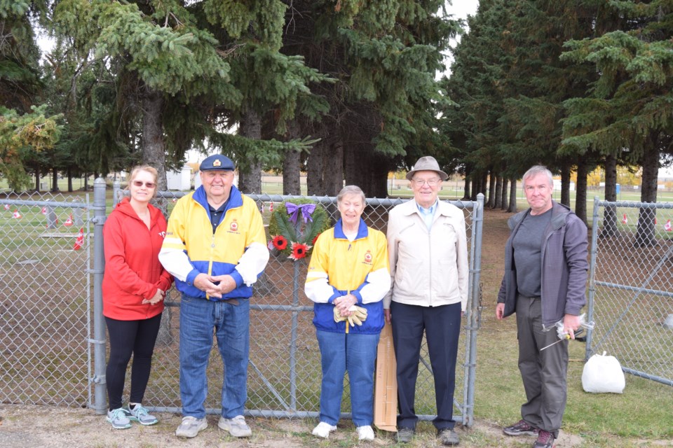 A small group of volunteers, comprised mostly of Royal Canadian Legion members, planted over 200 flags at Barrhead's Field of Honour on Oct. 2. Pictured from left are Town of Barrhead Coun. Shelley Oswald, Legion members Herman and Inga Barkemeyer, Legion vice-president Chuck Mortimer and his son Ed Mortimer.