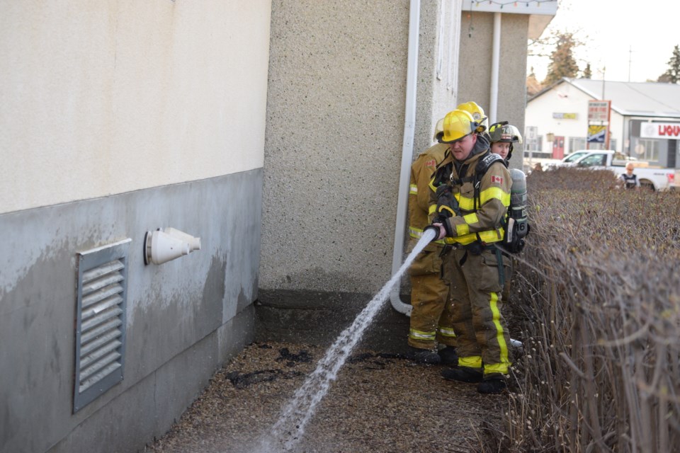 Barrhead Regional Fire Services firefighter dilutes the fuel that was used in an attempt to start the St. Anne Parish Catholic Church on fire on May 1.