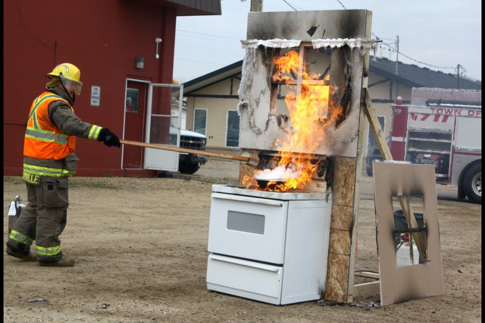 Pickardville firefighter Raegan Moon demonstrates what happens when water is put on a grease or oil fire during the 2023 Fire Prevention Week event Sept. 30 at the Town of Westlock fire hall.    