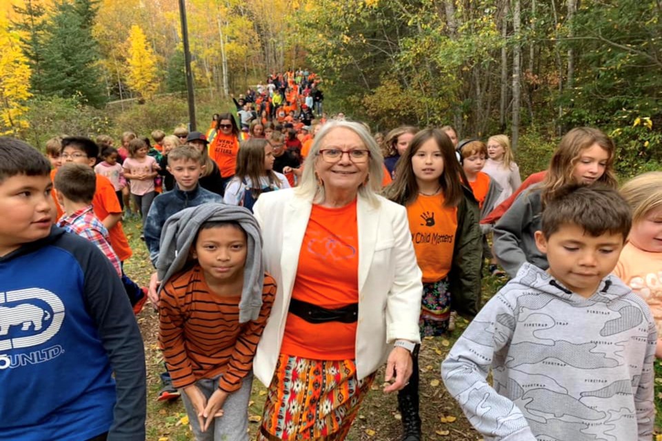 There were a number of events and activities related to the National Day for Truth and Reconciliation throughout Athabasca in the two weeks leading up to Sept. 30, including at area schools and through the Athabasca Native Friendship Centre. Pictured, Aspen View Public School FNMI family liaison Alma Swan leads a sea of orange, hundreds of students, from Landing Trail Intermediate School in Athabasca through the Muskeg Creek Trails near the school Sept. 29. It was just one of the events planned across the country to recognize Canada’s National Day for Truth and Reconciliation. 