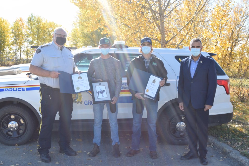 RCMP Eastern District Supt. Shane Ramteemal and Barrhead Detachment Commander Bob Dodds award Nolan Tuininga and Quinn Meunier with District Commander's Certificate of Appreciation. Pictured from left are Sgt. Bob Dodds, Nolan Tuininga, Quinn Meunier and RCMP Eastern District Supt. Shane Ramteemal.
