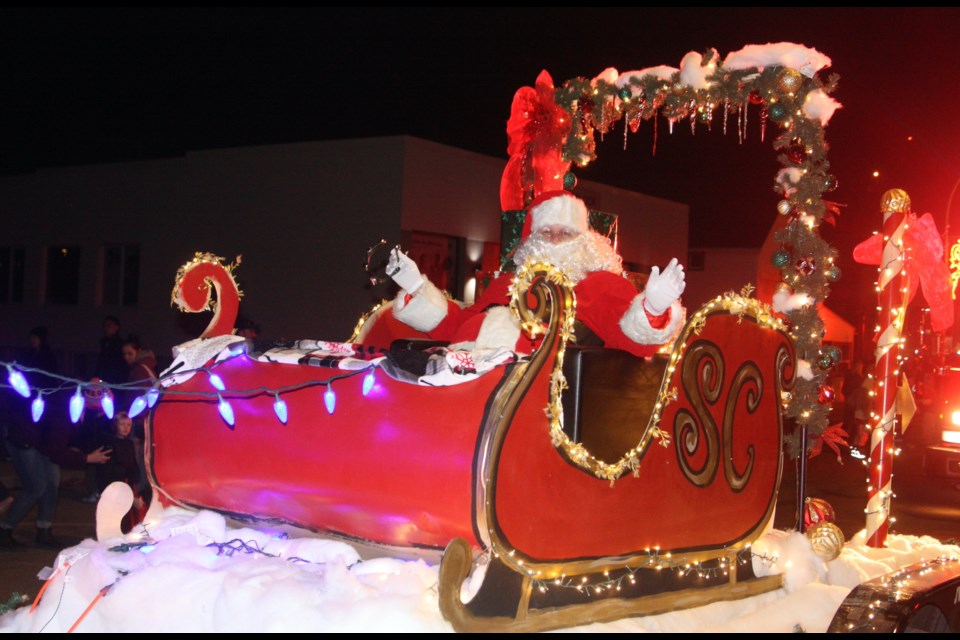 Santa Claus waves to the crowd from his sleigh on the back of the Town of Westlock float in the Christmas Light-up parade on Nov. 17. After the parade, Santa headed to the Westlock Memorial Hall for pictures with children while other festive-themed activities were hosted in other parts of the hall. 