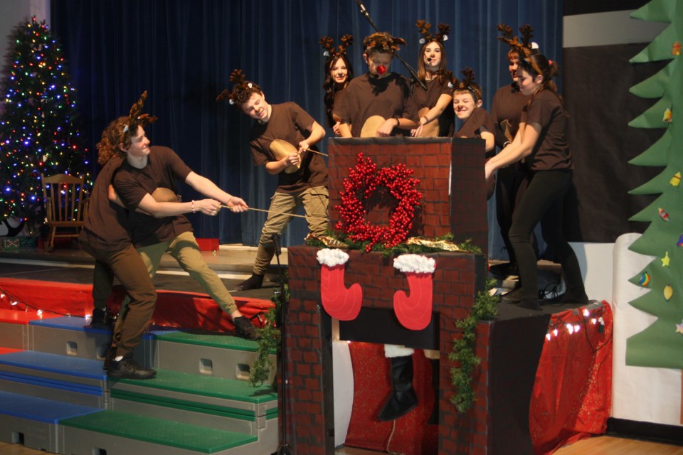 Santa's reindeer try to pull Santa Claus (Mylee Evans) out a chimney that he was too fat to go down in this scene from "Santa Cancels Christmas!", a play performed at the Pembina North Community School Christmas concert on Dec. 14. The reindeer are played by (in no particular order) Anna Ewasiw, Mason McLean, Jolyn Terlouw, Jenna Lawrene, Kadence Sauter, Niklas Boelman, Dayce Madson, Memphis Durand and Kohen Rau.