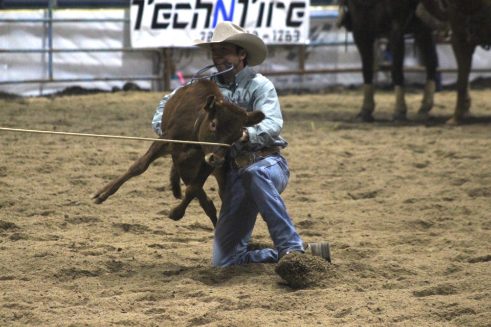 Having successfully lassoed the calf, Jordan Richardson hoists it into the air during the “tieing down” portion of the tie-down roping event at the WRA finals on Sept. 15.