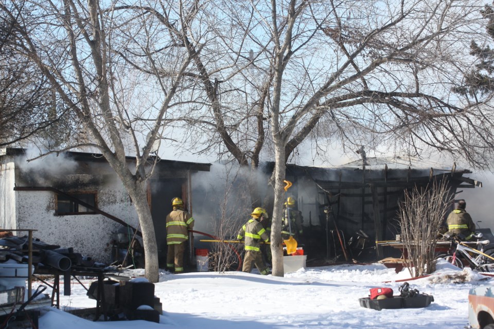 Smoke billows out of a structure in the community of Pibroch on the afternoon of March 11.