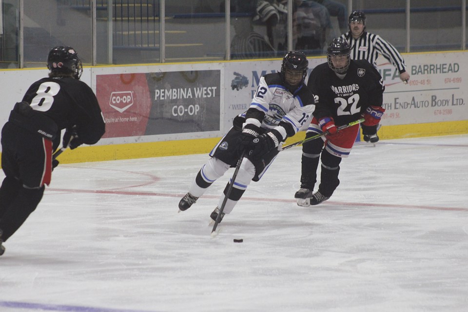 The Barrhead Bombers junior hockey team hosted their season-opener against the AMP Warriors on Oct. 1 at the Barrhead Agrena. Though the Bombers played well and managed to gain a 3-2 lead in the third period, they ran out of steam at the end and their opponents were able to tie up the score with less than two minutes left on the clock. The Warriors then notched the winning goal less than a minute into overtime, winning 4-3. The Bombers’ next home game will take place Oct. 21 versus Vegreville. PICTURED: Bombers’ forward Zion Fraser pushes the puck down the ice towards AMP’s net in the second period.