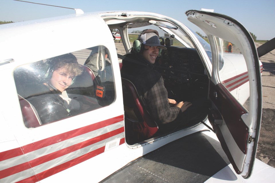 Brothers Joshua Allen and Brayden Forest smile from the cabin of a plane about to take off from the Westlock Flying Club Sept. 9.