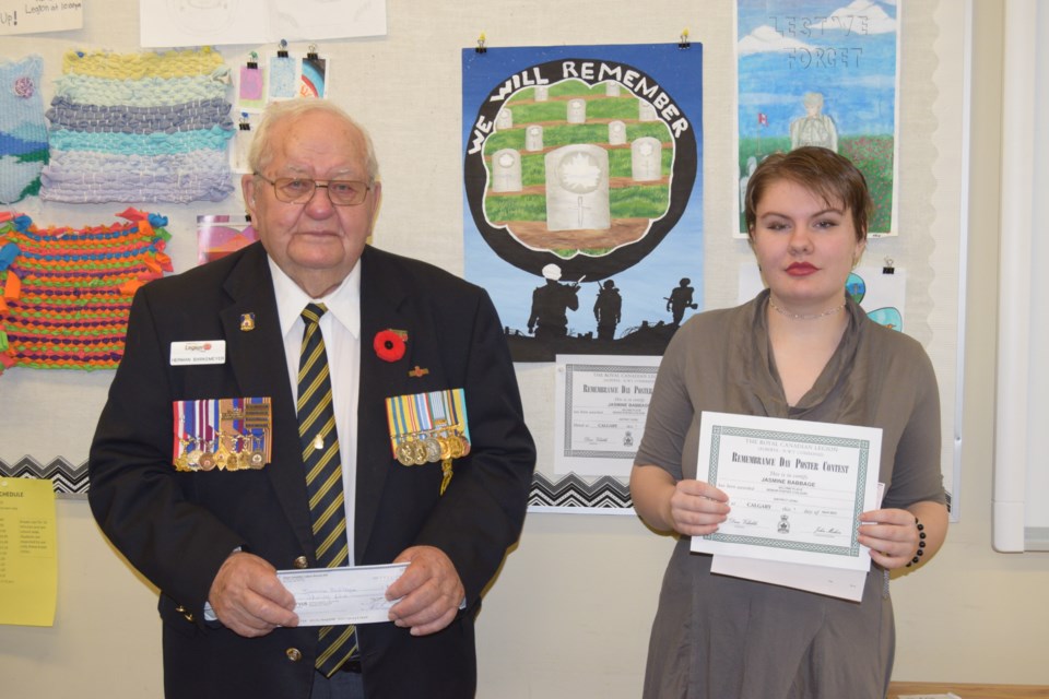 Barrhead Royal Canadian Legion member Herman Barkemeyer presents Barrhead Outreach School May 16 student Jasmine Babbage with a cheque and certificate for her placing second in the province in the Senior Colour Poster contest.