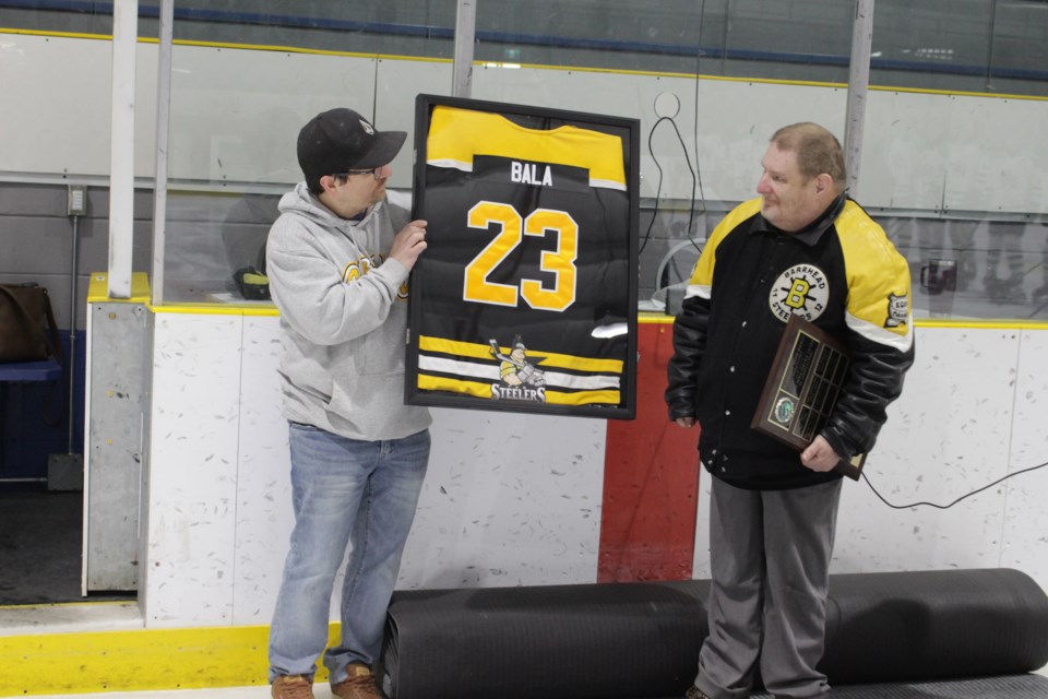 Mark Bain, from the Barrhead Minor Hockey Association (left), presents Steve Bala with his own Steelers jersey.