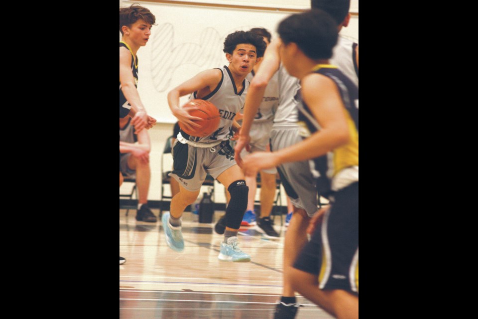 The Edwin Parr Composite Predators hosted the 3A North Central Zone boys basketball tournament March 11-12, earning a bronze, while the girls were in Westlock but could not manage a medal. ABOVE: JP Sarmiento breaks into the key while several Barrhead defenders try to keep him away Friday afternoon.