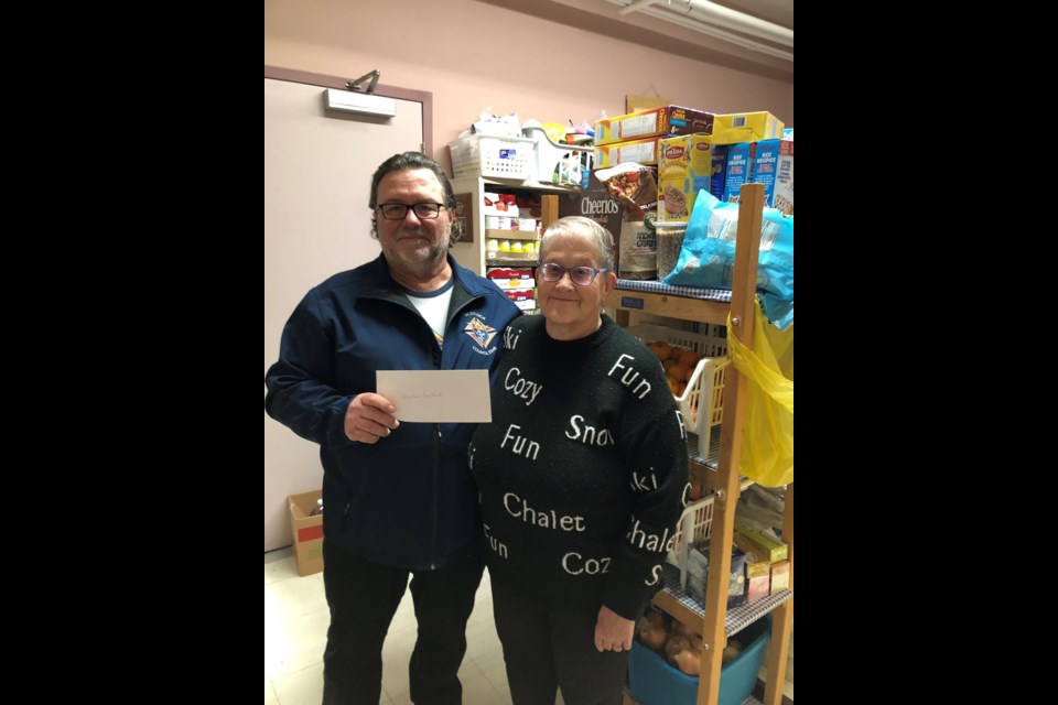 The Knights of Columbus Westlock Council recently donated a total of $3,250 to local organizations to help spread some Christmas cheer. In this first photo, K of C treasurer Bob Primeau presents a $2,000 cheque to Sharon Kennedy, president of the Westlock Food Bank.