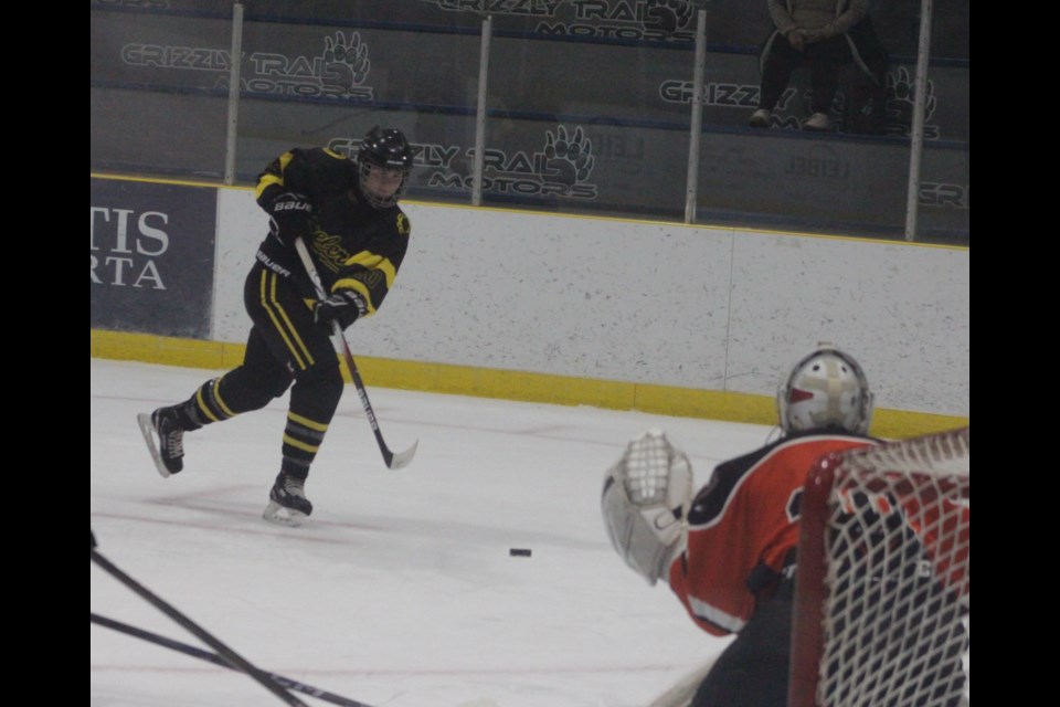 Barrhead Steeler  Levi DeVries taking a shot form the top of middle of the right face-off circle.