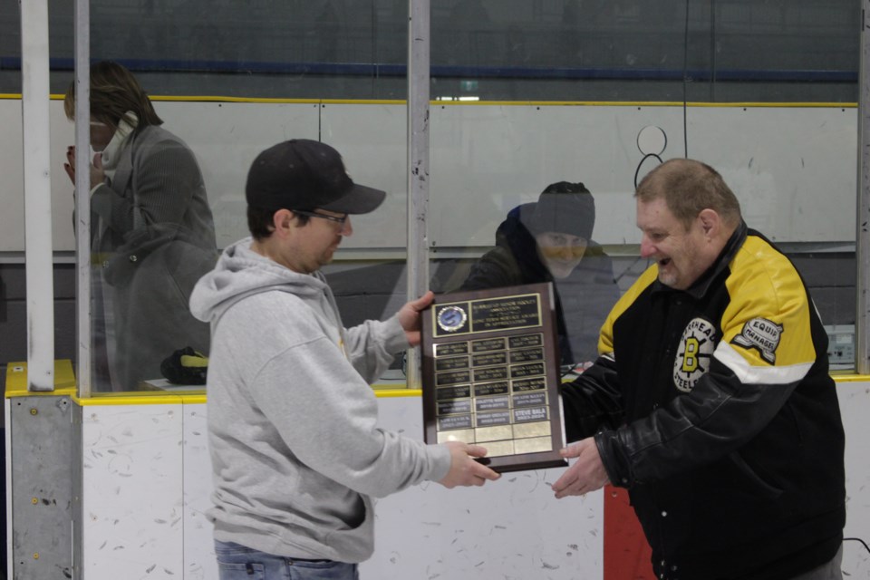 Mark Bain (left) from the BMHA presents Steve Bala with the association's Long Term Service Award during a pregame ceremony before the Steelers versus Drayton Valley game at the Agrena on Jan. 5.