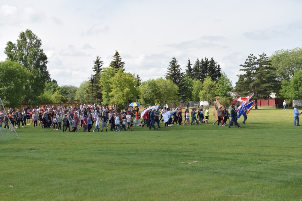 More than 100 people joined the walk at Cecile Martin Park on June 20 to commemorate National Indigenous Day including this group of Grade 4 to 6 Barrhead Elementary School students watching a smudging ceremony.