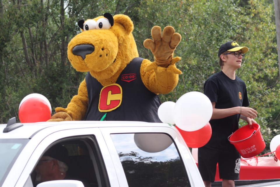 Co-op store mascot Cooper waves from the back of the truck pulling the Neerlandia Co-op's float.