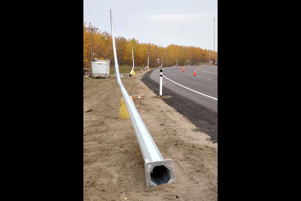 Crews with Highline Electrical Constructors were in town last week, adding nine new streetlights to the north side of Highway 55 to complement the other improvement work that has gone on all summer. The underground wiring work was completed in the days prior to Sept. 28. Pictured, the line of streetlights on their backs waiting to be put upright.