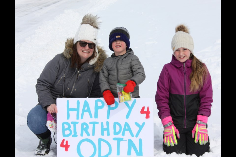 Four-year old Odin Purdy, with mom Michelle and sister Addison, hold up one of the signs thrown their way March 31 as members of the community put together a convoy they called Birthdays on Wheels, to help celebrate the birthdays of local kids unable to have a party because of COVID-19.
Photos by Chris Zwick/T&C