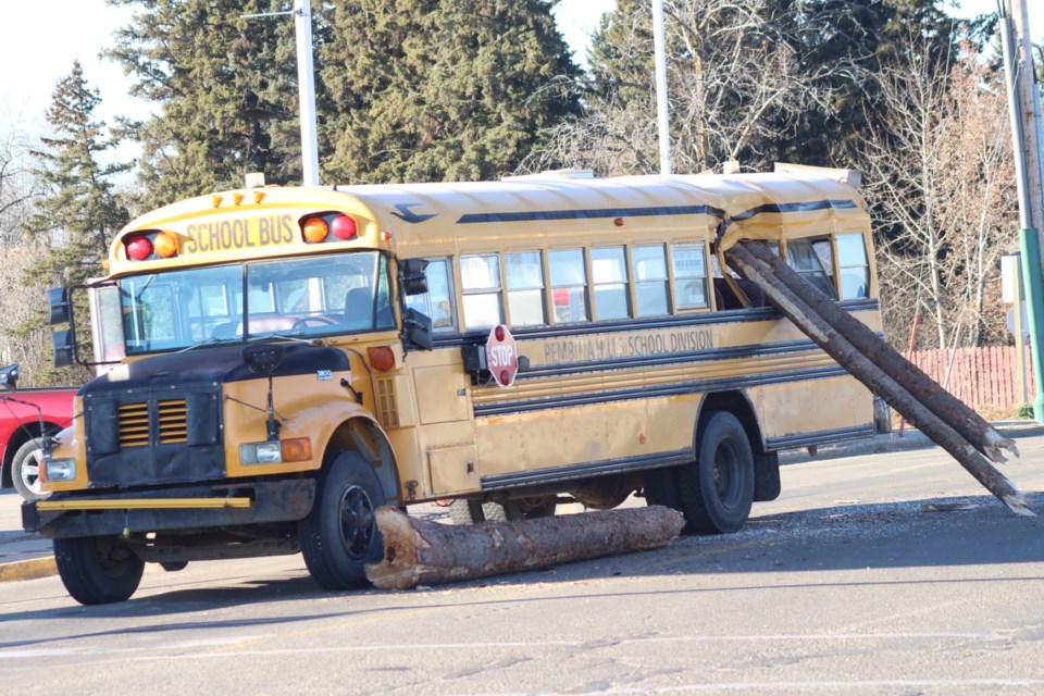 A pair of logs hang out the window of a Pembina Hills school bus which was involved in a freak accident with a logging truck on the morning of Nov. 2. Police are investigating.