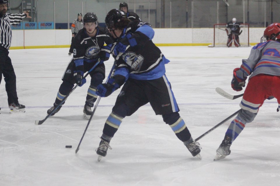 Goaltender John Zeise was instrumental in earning the Barrhead Bombers first two wins of the season. Here, Zeise makes a save against Stavely Mustangs forward Grady Vandenhoek on Oct. 13. Barrhead's Coby St. Arnaud is in the background.