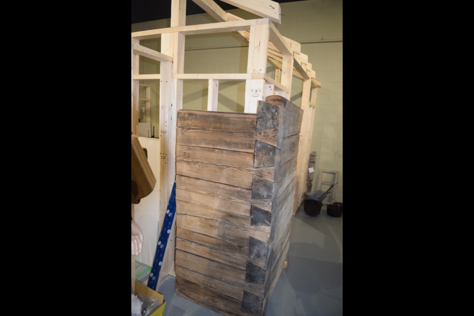 A local business created the log facade that will be on the outside of one of the home displays.